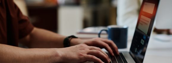 Businessman typing on laptop keyboard